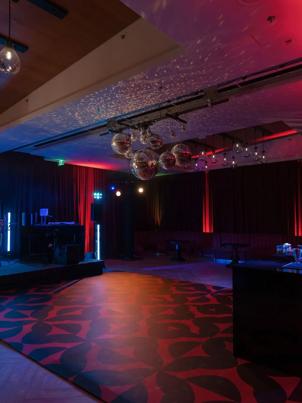 Wedding after-party lounge with disco balls and red lighting