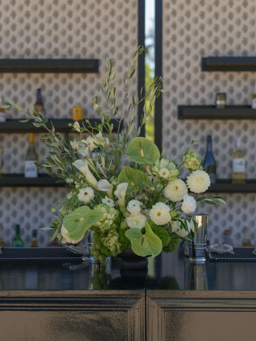 Anthurium and dahlia floral arrangement on a custom wedding bar