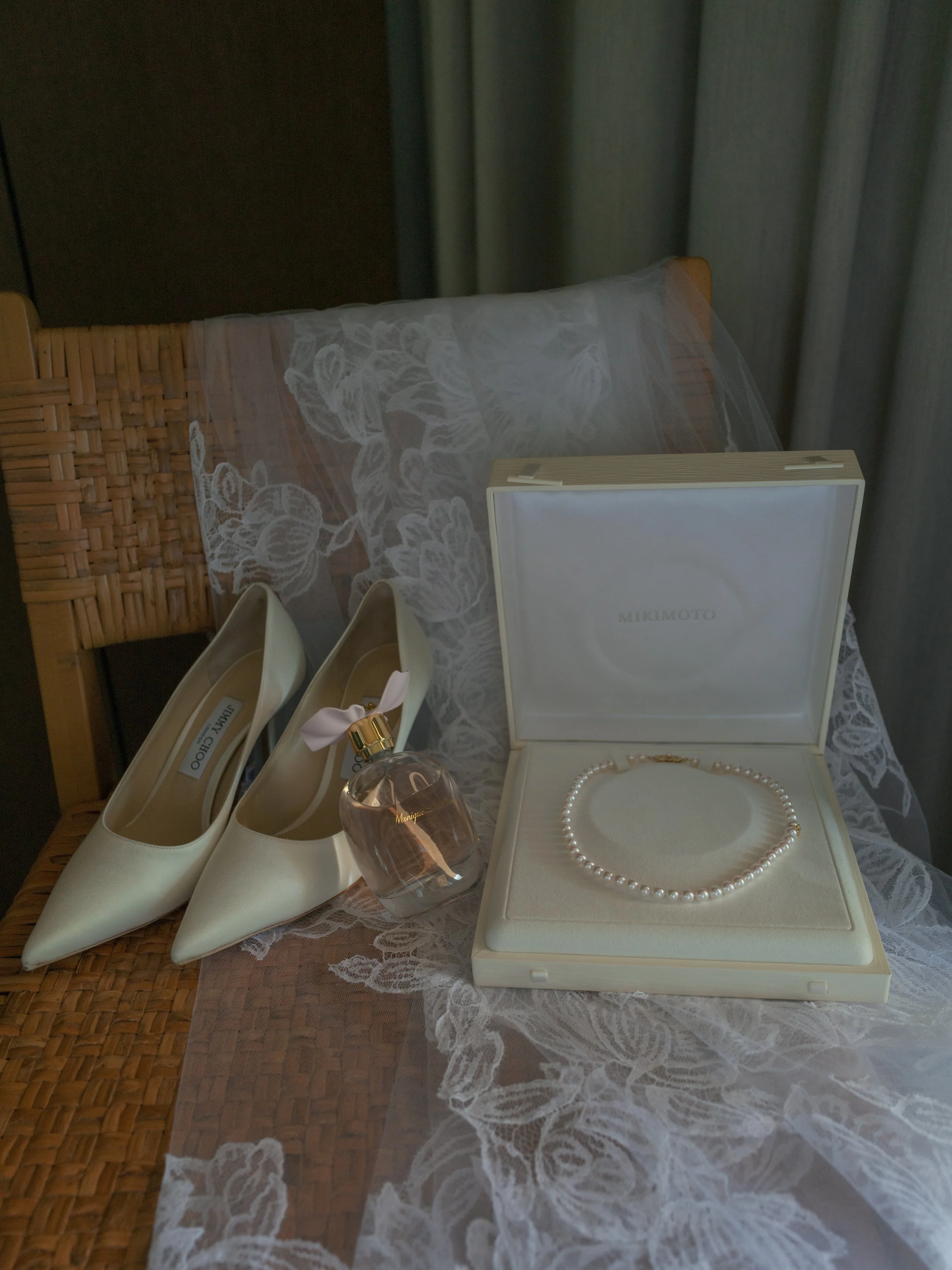 Bridal details with ivory heels, pearls and lace veil