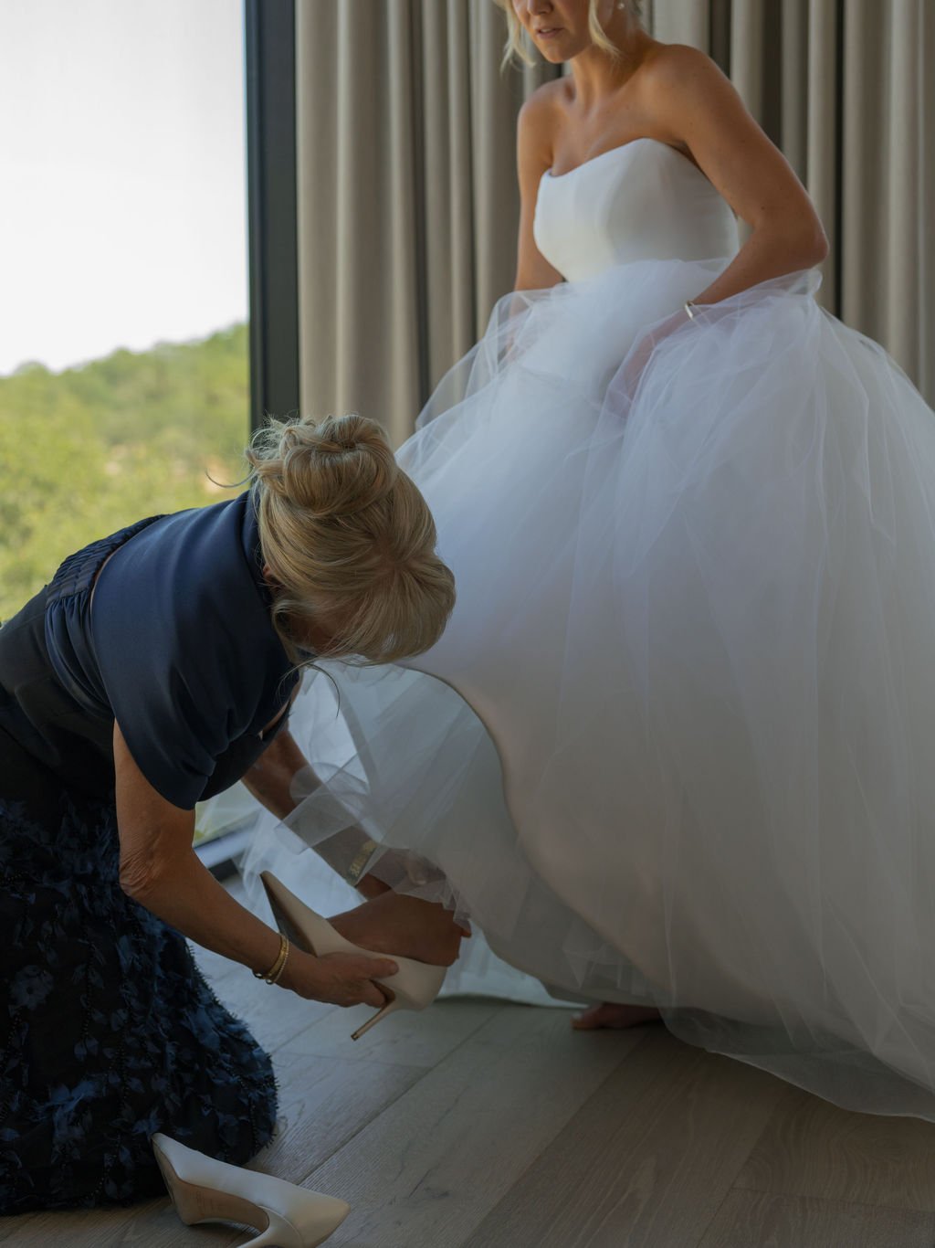 Bride stepping into her heels in a tulle Vera Wang ball gown
