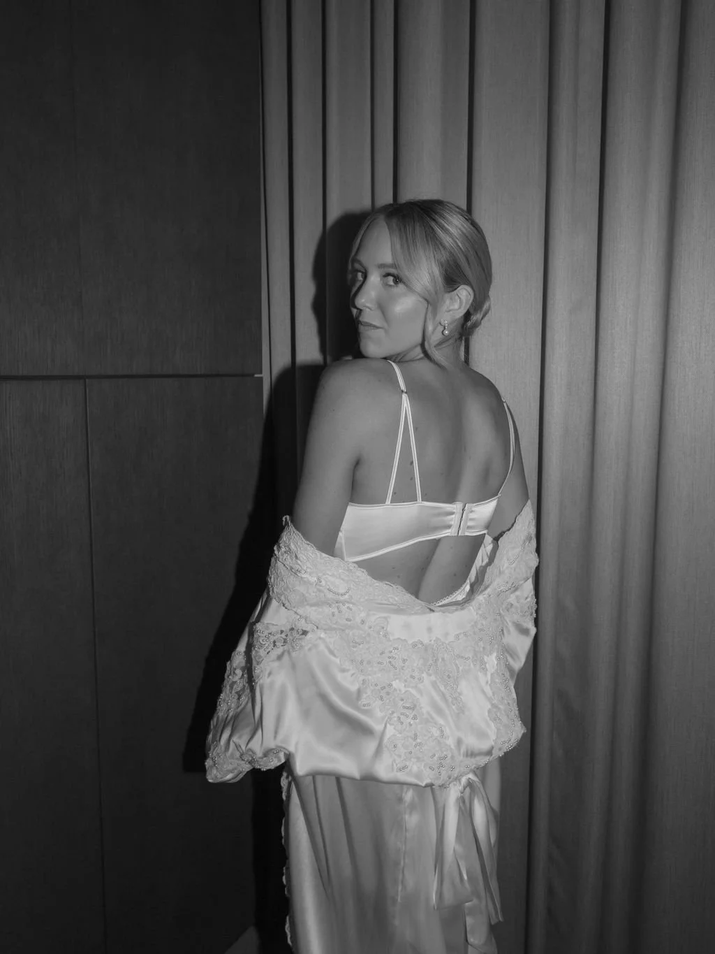Black-and-white bridal portrait while getting ready