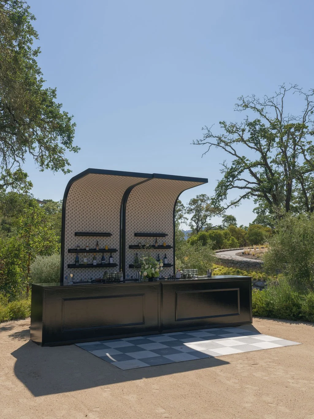 Custom wedding cocktail hour bar with checkered floor in Sonoma wine country