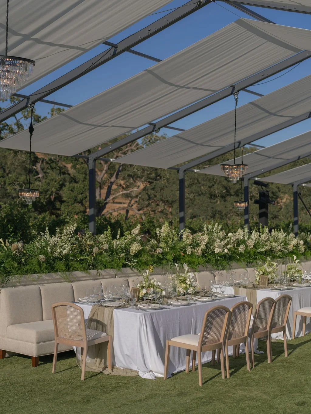 Wedding reception banquette seating under crystal chandeliers