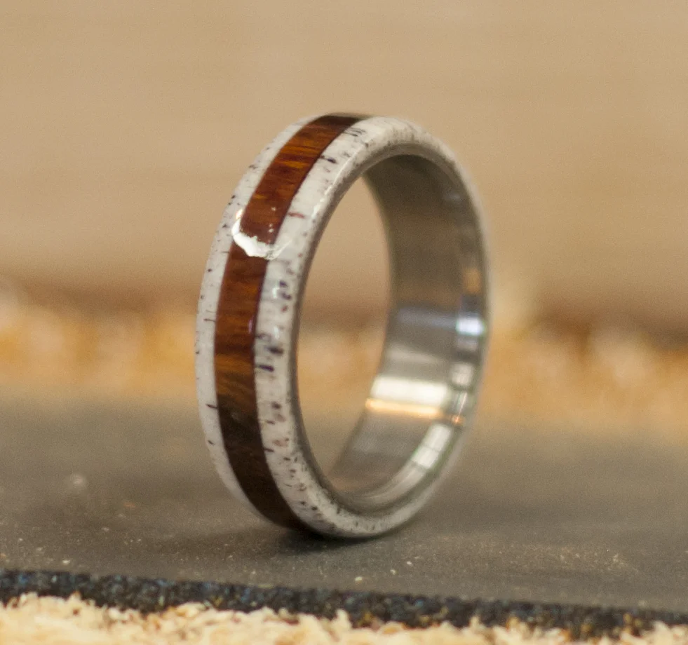 Handmade wood and antler wedding ring. Elk antler on either side of ironwood, set on a titanium wedding band.
