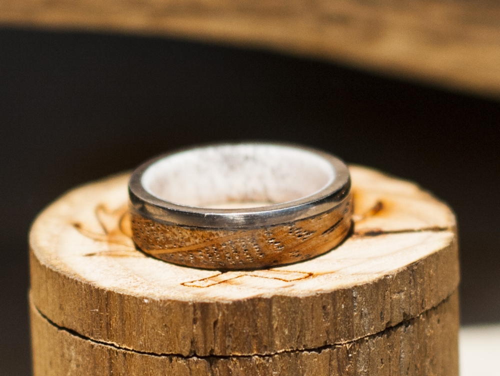 Wedding band hand made from antler and a whiskey barrel.
