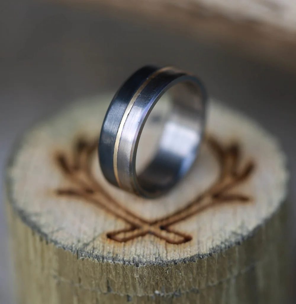 Men's Titanium Wedding Band Featuring Black Zirconium and Gold. Handcrafted by Staghead Designs.