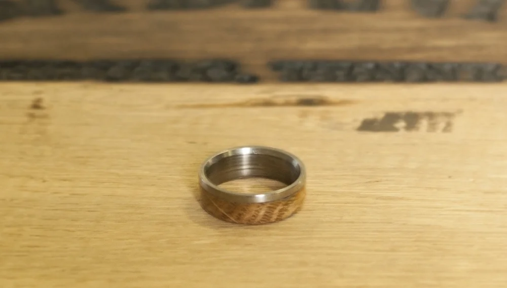 Titanium wedding ring with an overlay of whiskey barrel wood. Top View.