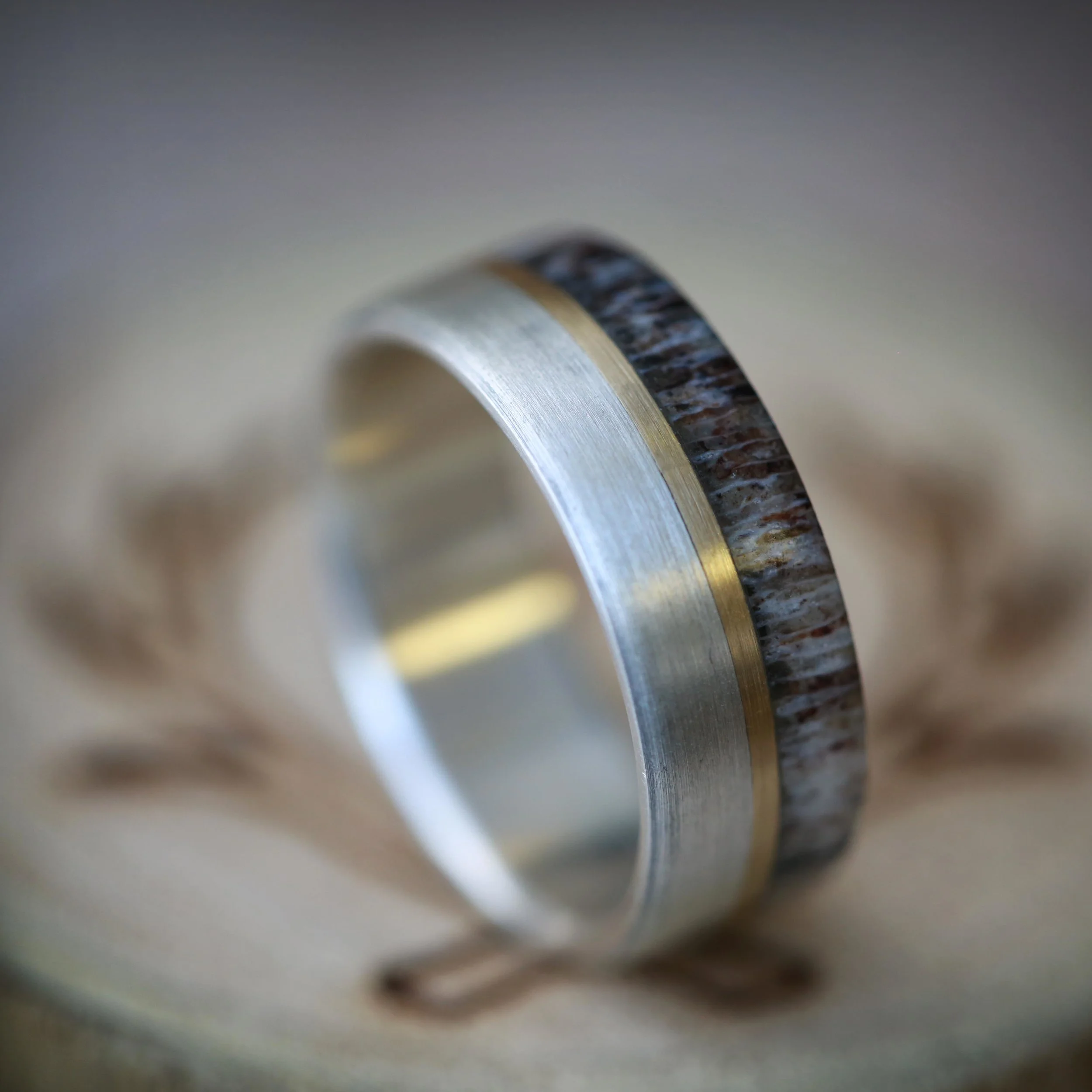 Unique Men's Wedding Ring Featuring Silver, Gold, and Antler. Handcrafted by Staghead Designs.