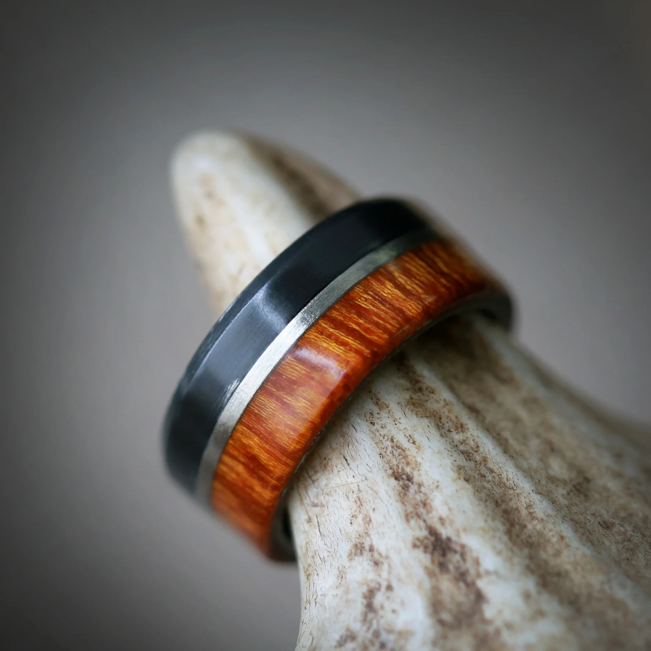 Unique Men's Wedding Ring with Black Zirconium and Wood. Handcrafted by Staghead Designs.