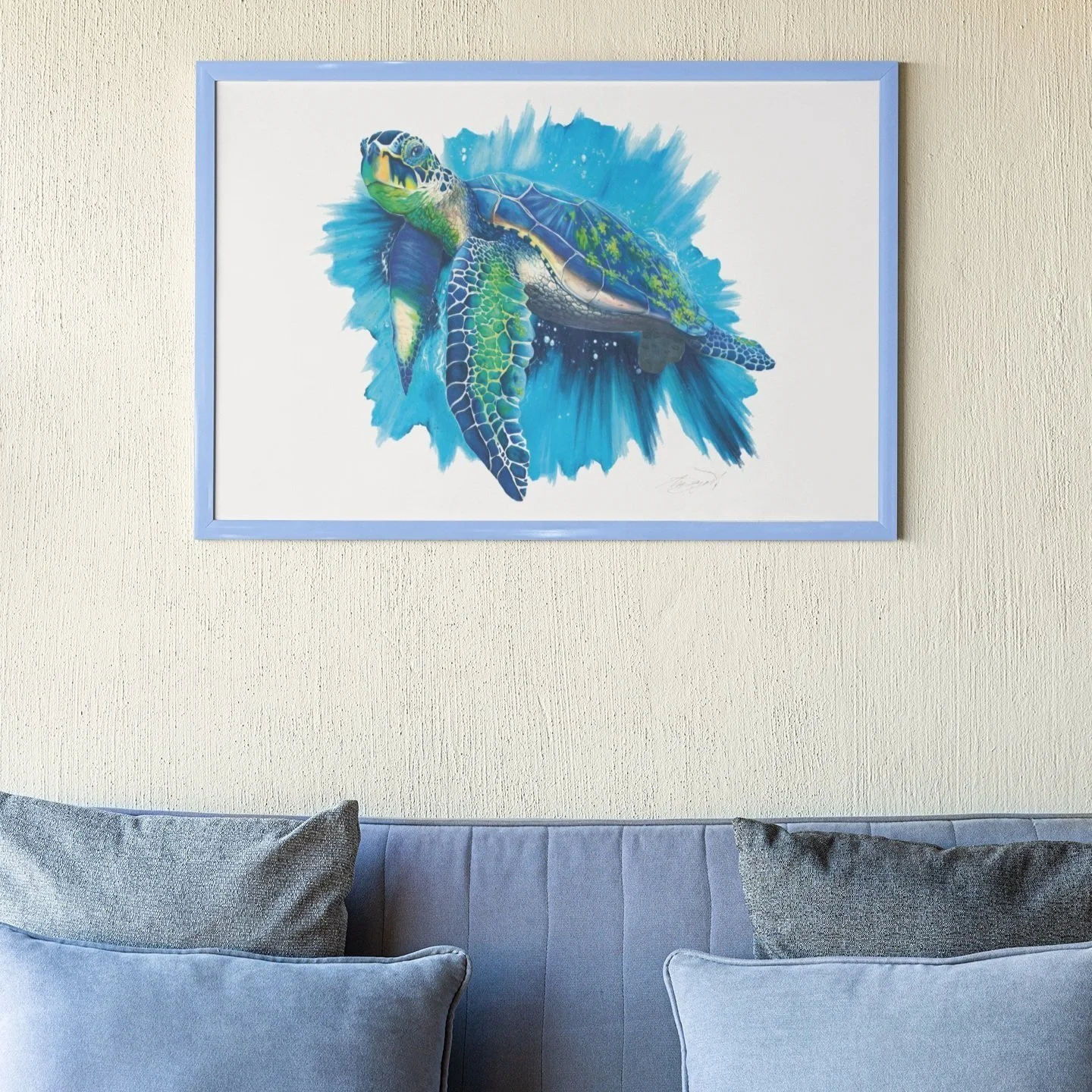 sea turtle fine art print in blue frame hanging over blue couch
