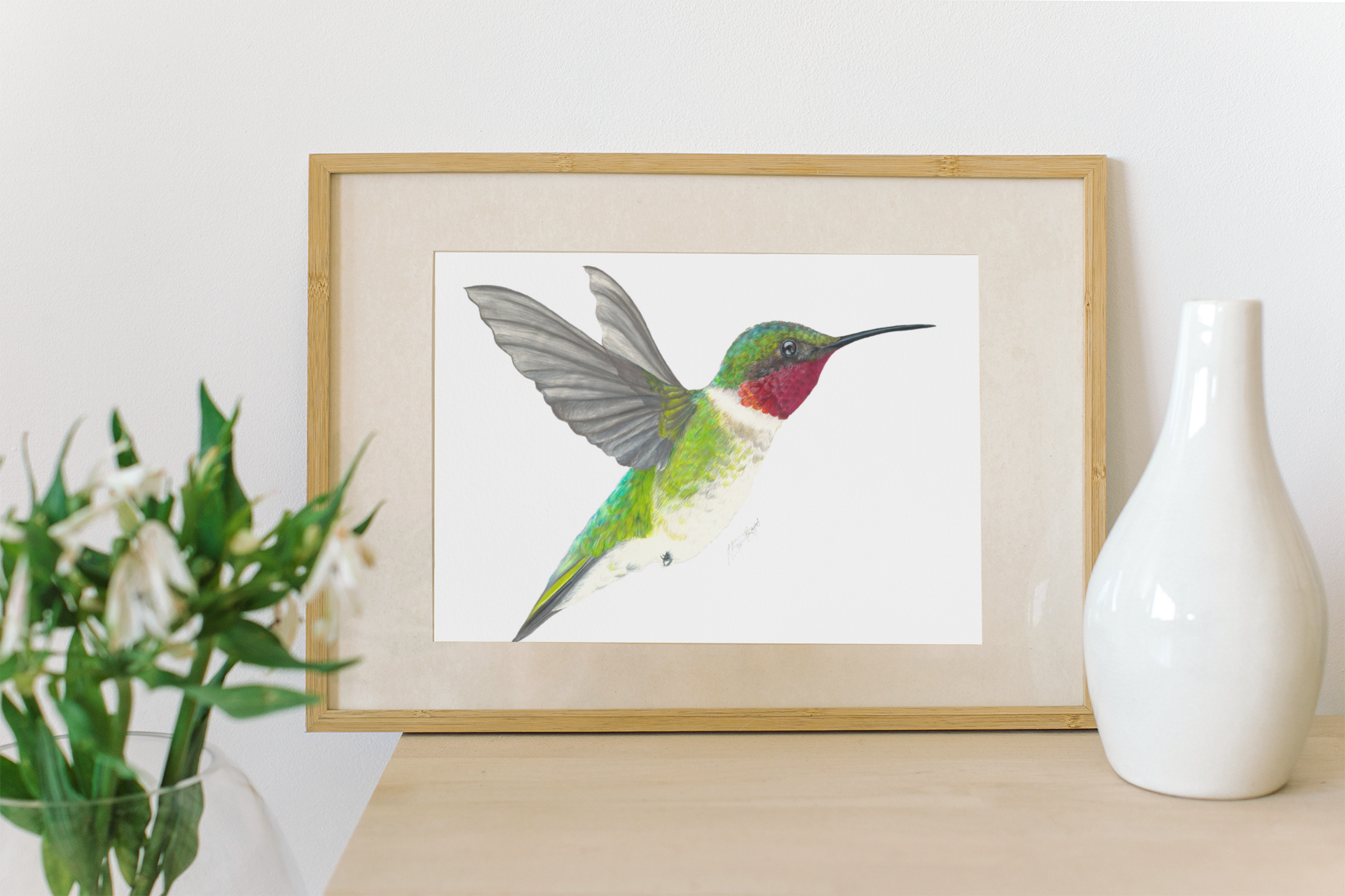 hummingbird fine art print framed sitting on table