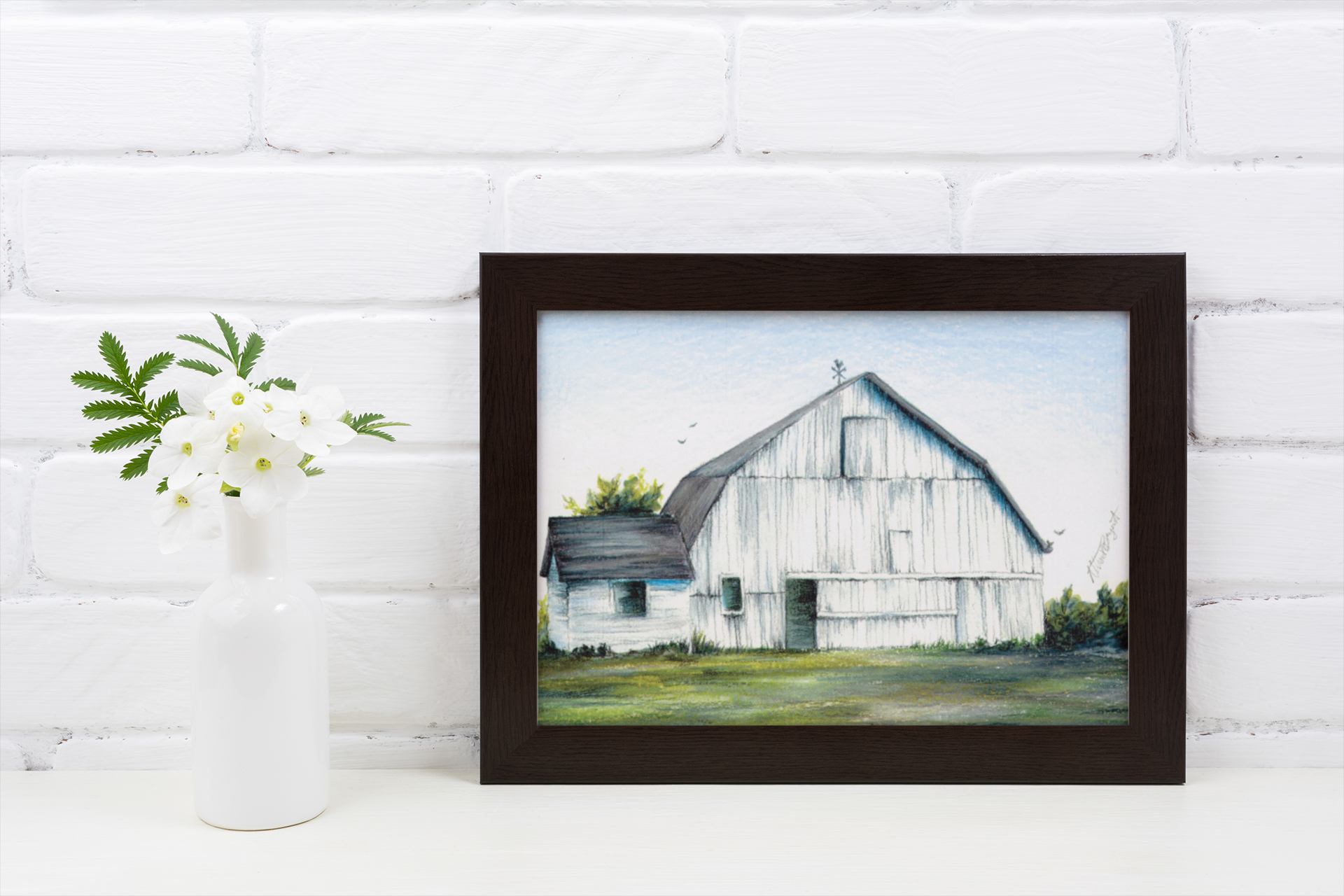 white barn fine art print in frame sitting on table