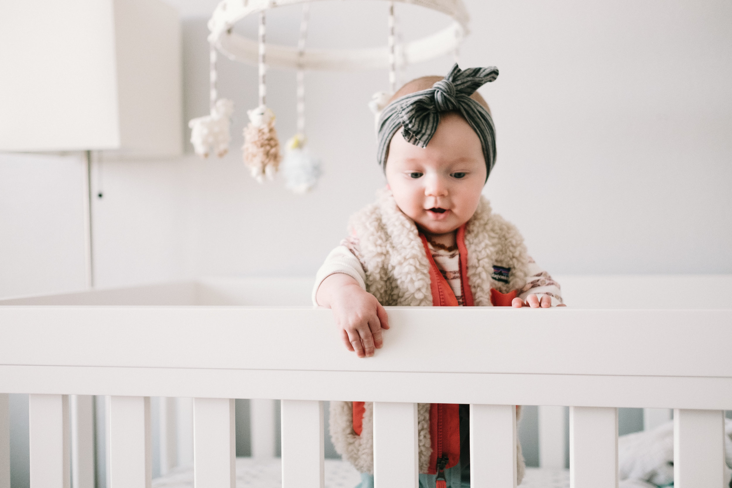 Baby girl standing in crib