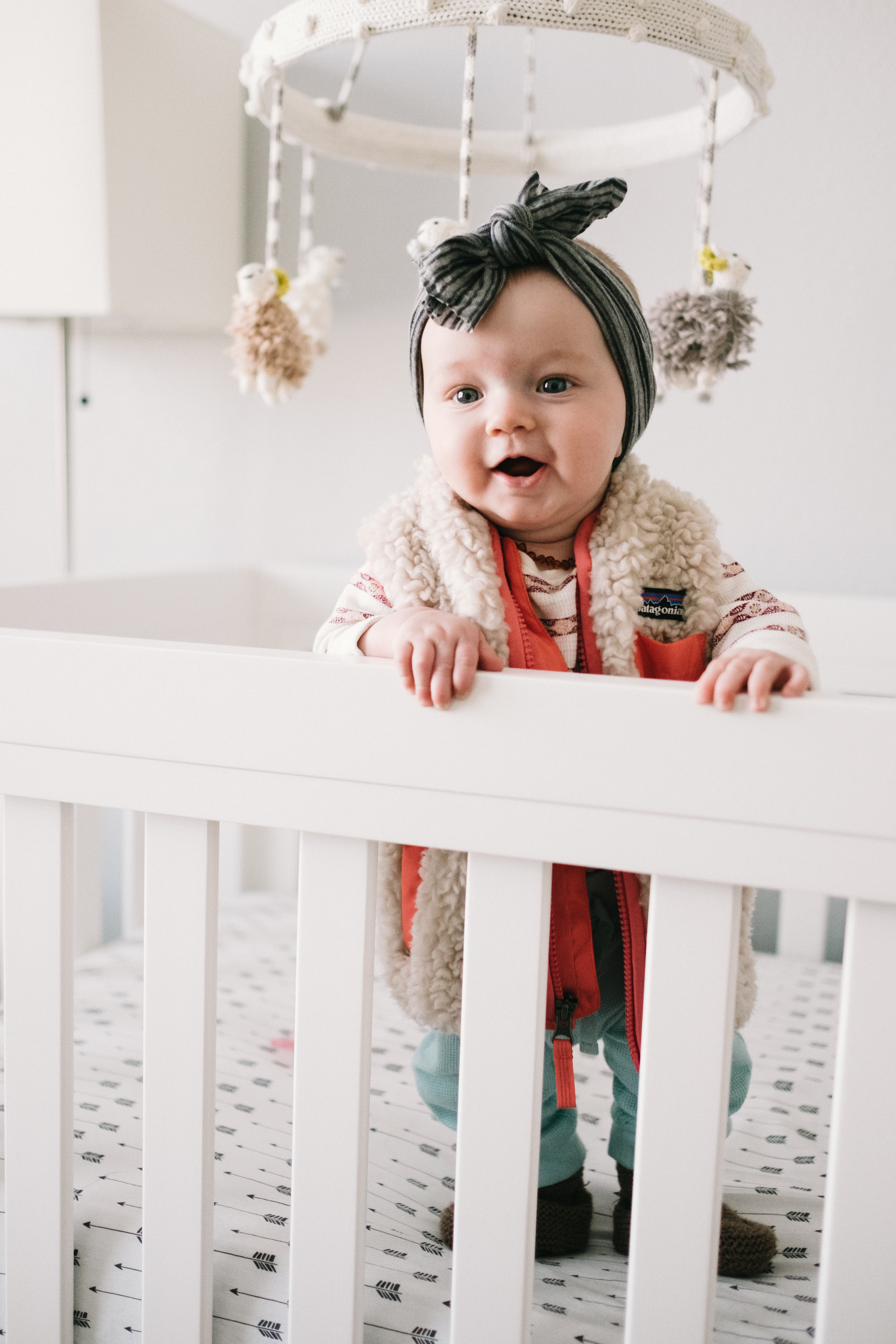Baby girl standing in crib