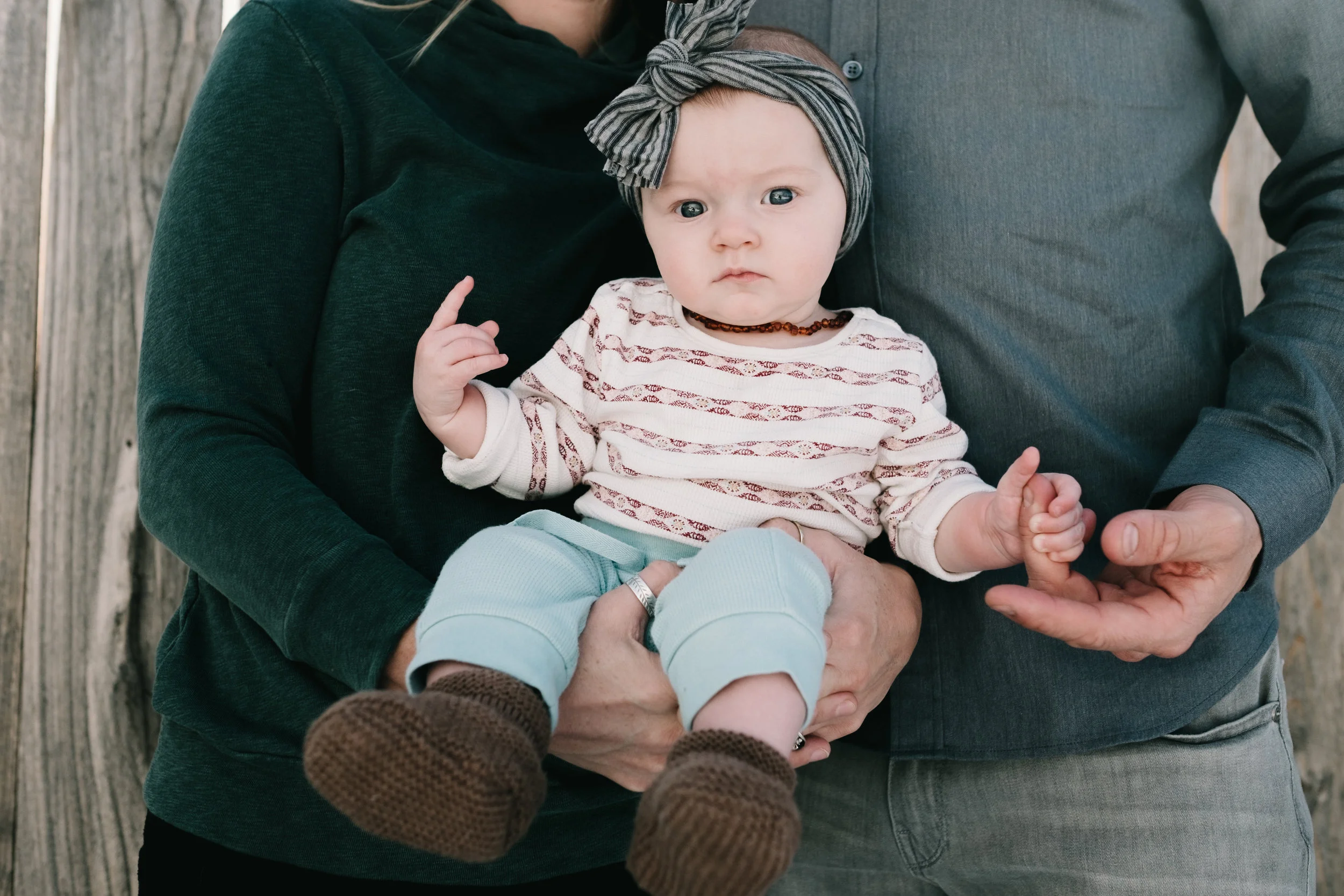 Portrait of baby girl held by parents