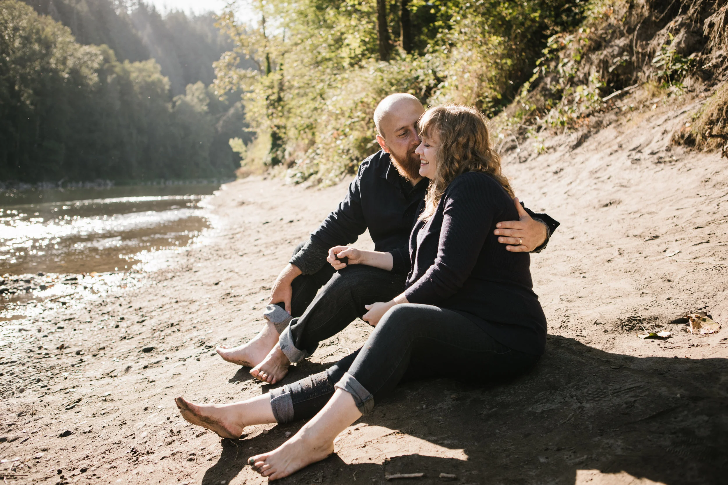 Husband and wife sitting by river