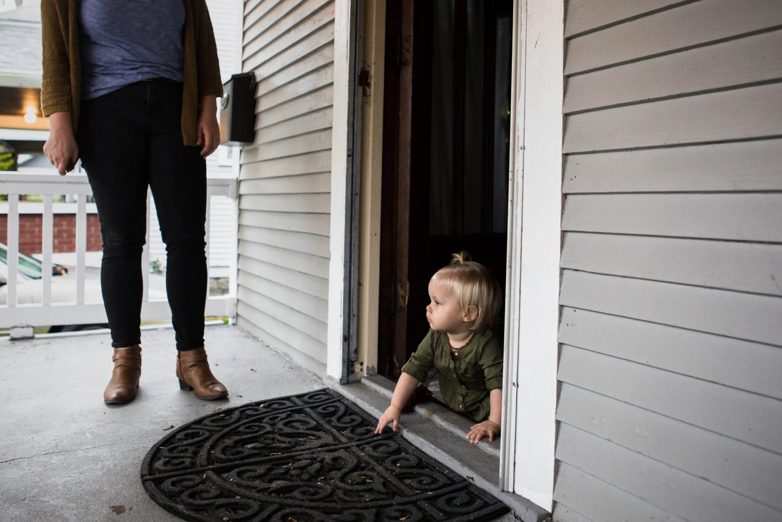 baby crawling out front door onto porch