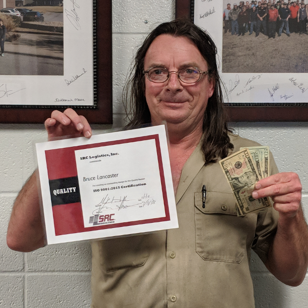 Bruce (above) shows his winnings from the quality banner contest. 