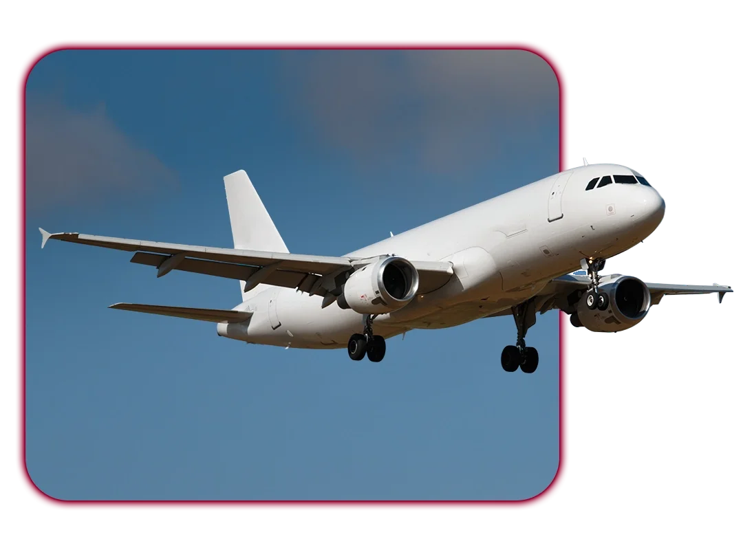 White commercial airplane in flight against blue sky.
