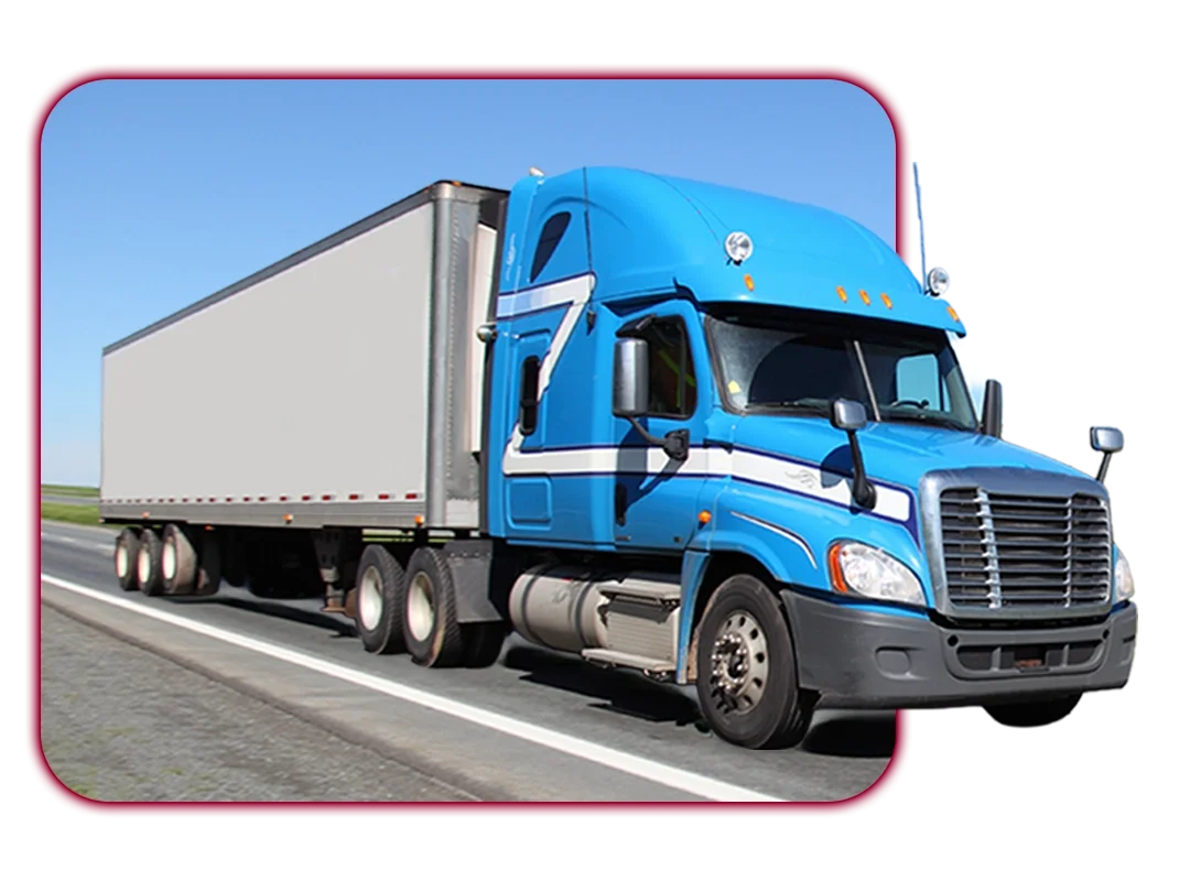 Blue semi-truck with a white cargo trailer traveling on an open highway under a clear blue sky.