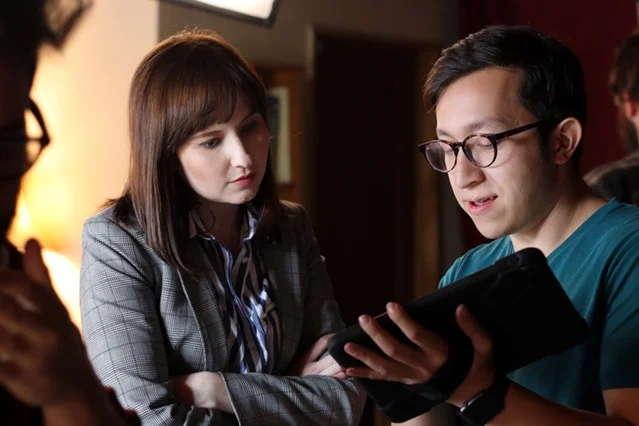 Corey explains a moment in the Guest Room to Mary Kate.