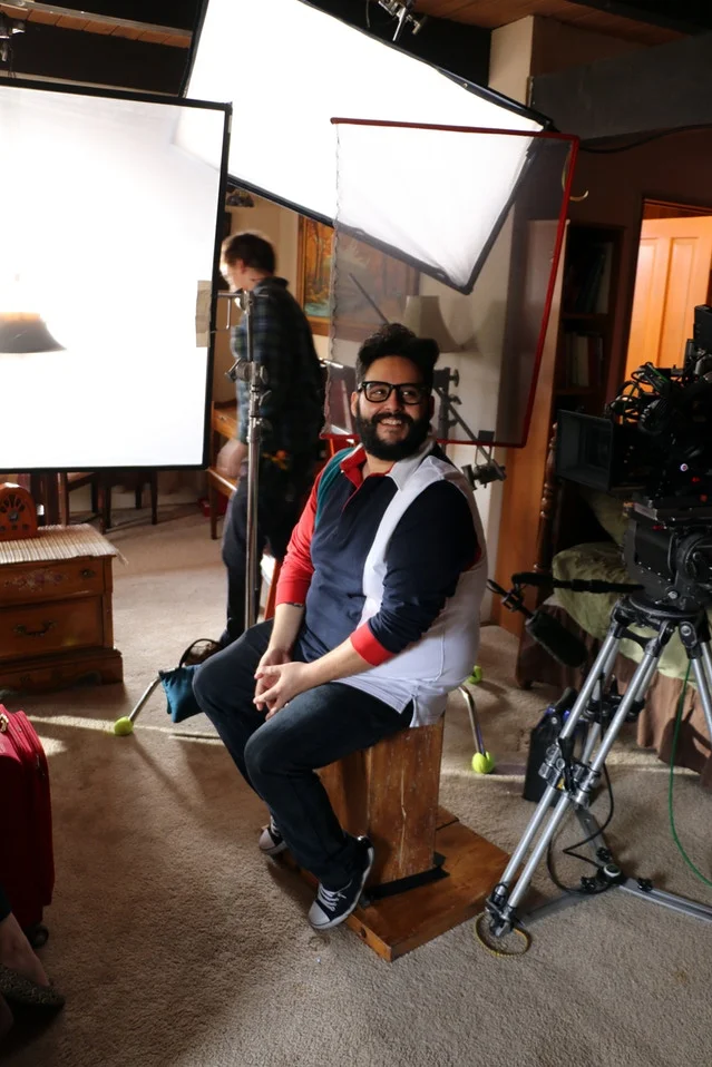 Steve sits on an apple box preparing for his OTS. Often times when an actor is not on camera his/her position is cheated to help sell the shot.