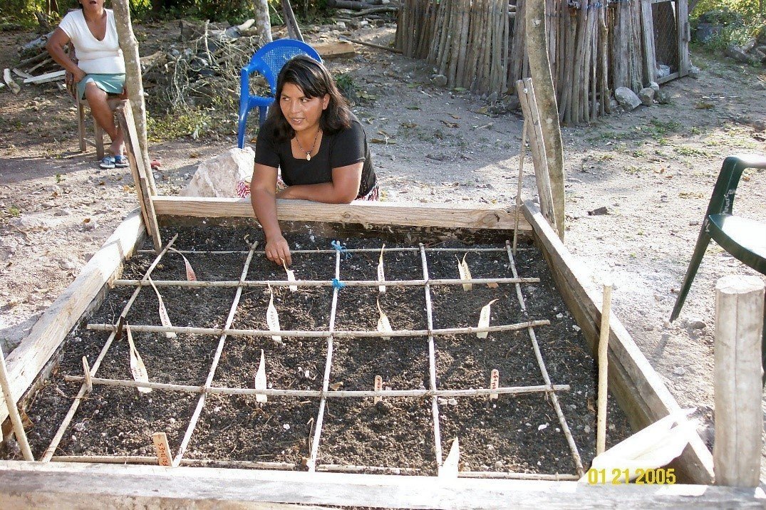 A woman proudly displays her WSRP square meter garden in El Remate, Guatemala