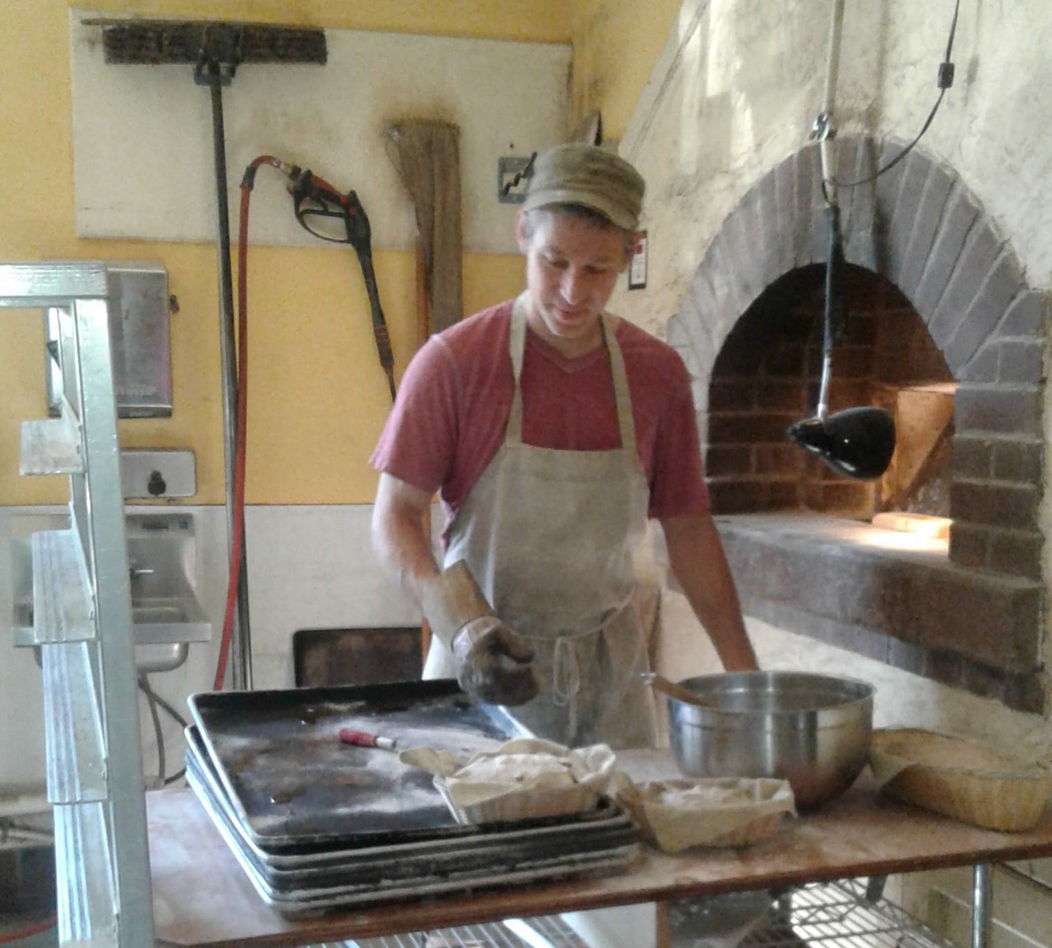 Saul of Sweetwater Bakery puts the finishing touch on their Hand-Shaped Sourdough Breads.