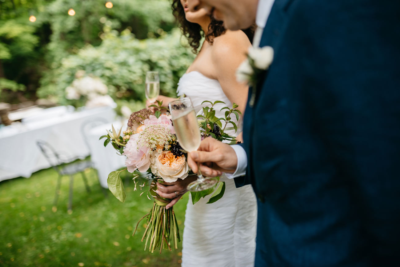 bride and groom with champagne after the ceremony at the pitcher inn in vermont