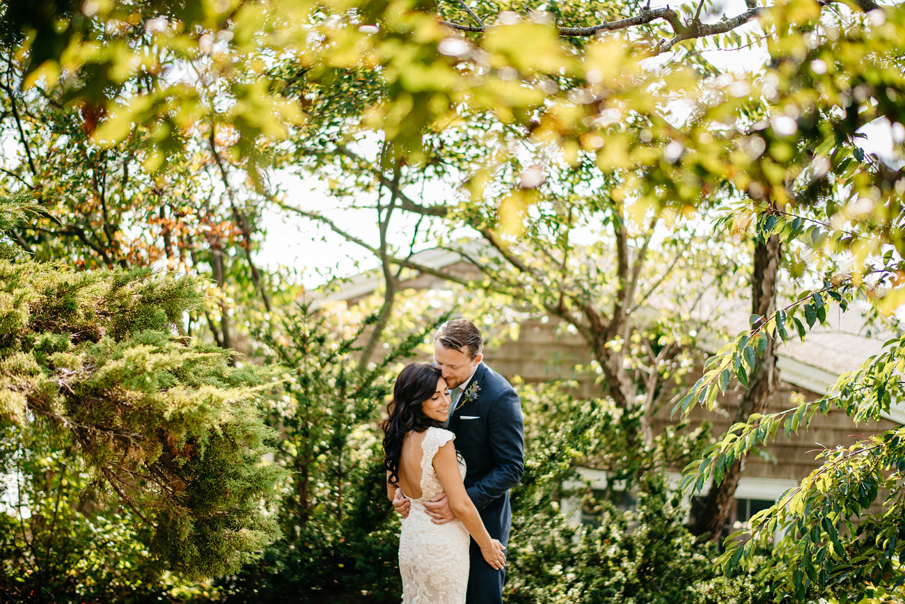 creative and beautiful eastern point yacht club in Gloucestor, MA creative portraits bride and groom holding each other