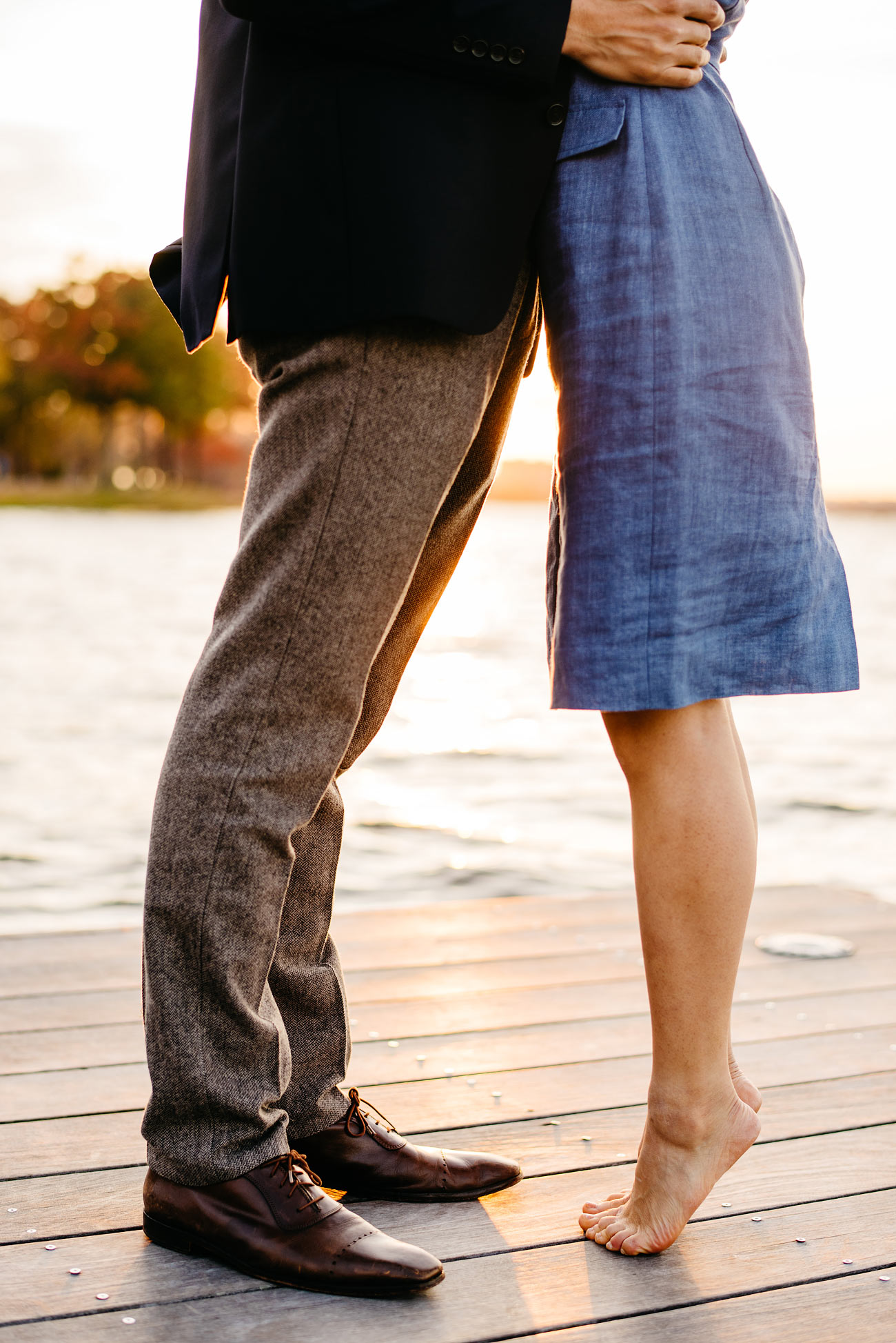 cute couple girl barefoot kissing on the dock at boston esplanade engagement photography