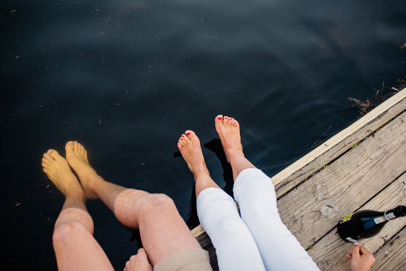 fun lifestyle cambridge engagement photos of couple sitting on the docks