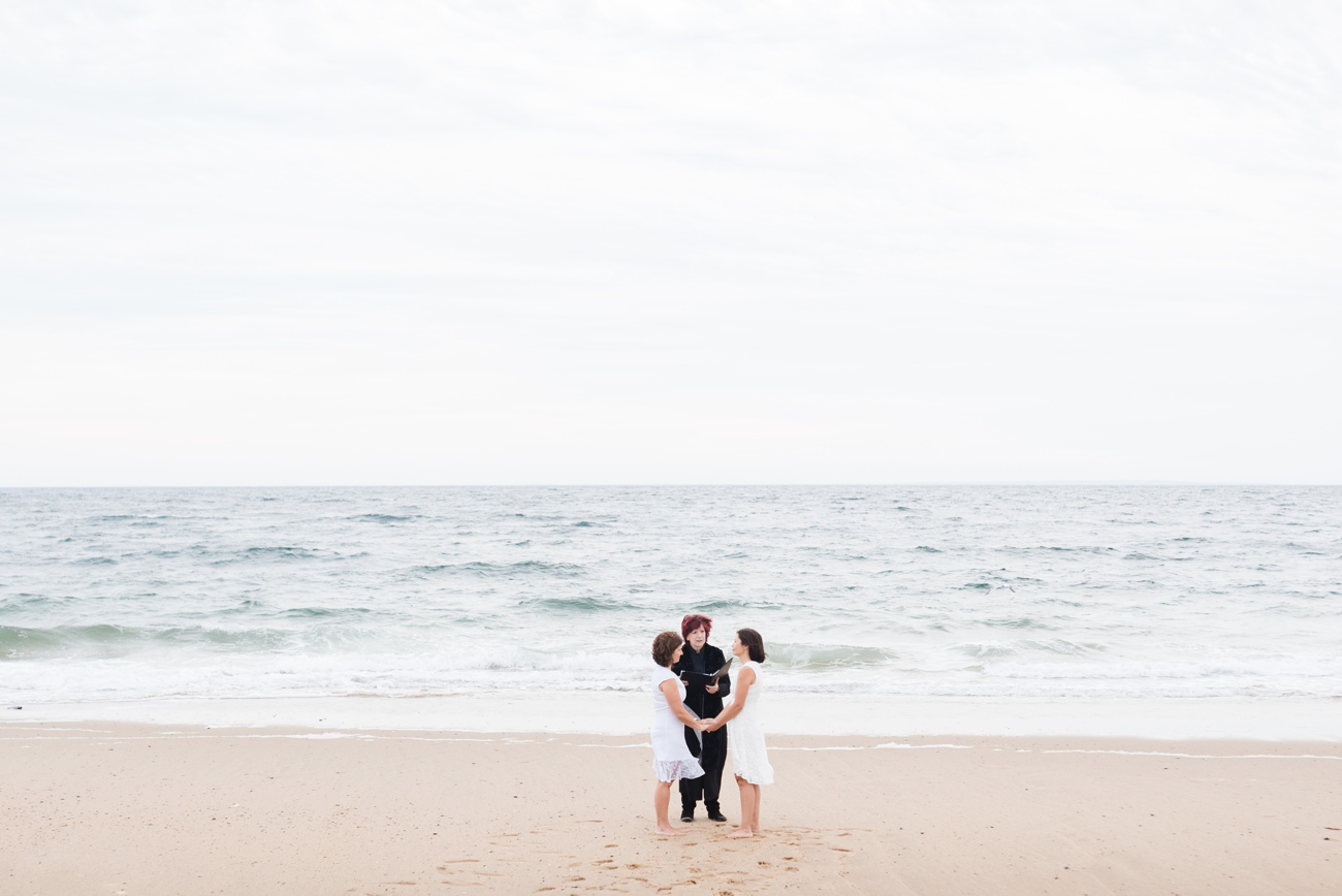 same sex couple getting married on the beach in provincetown