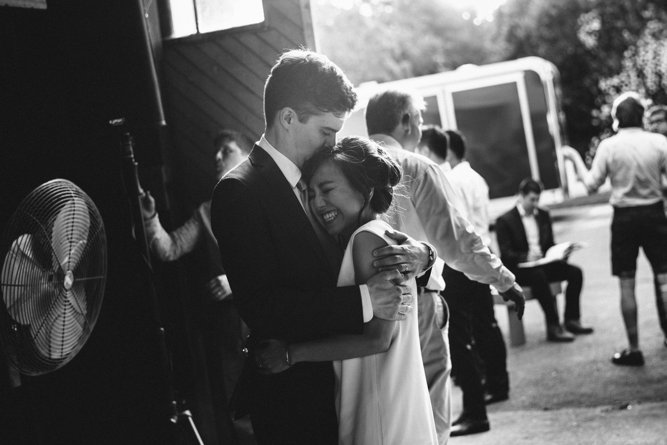 bride and groom hugging each other in a new hampshire barn