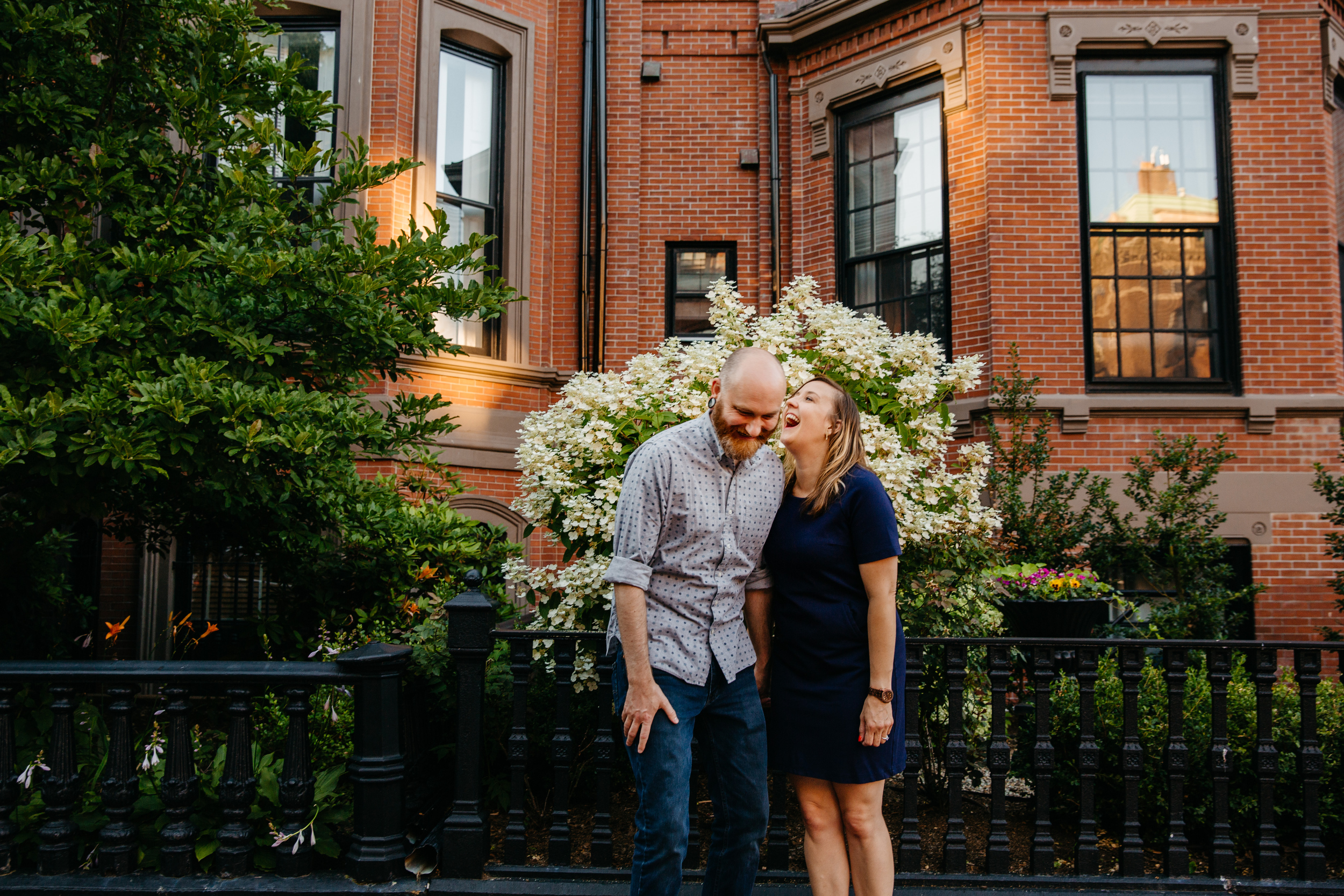  fun engagement inspiration with couple laughing in front of a boston brownstone 