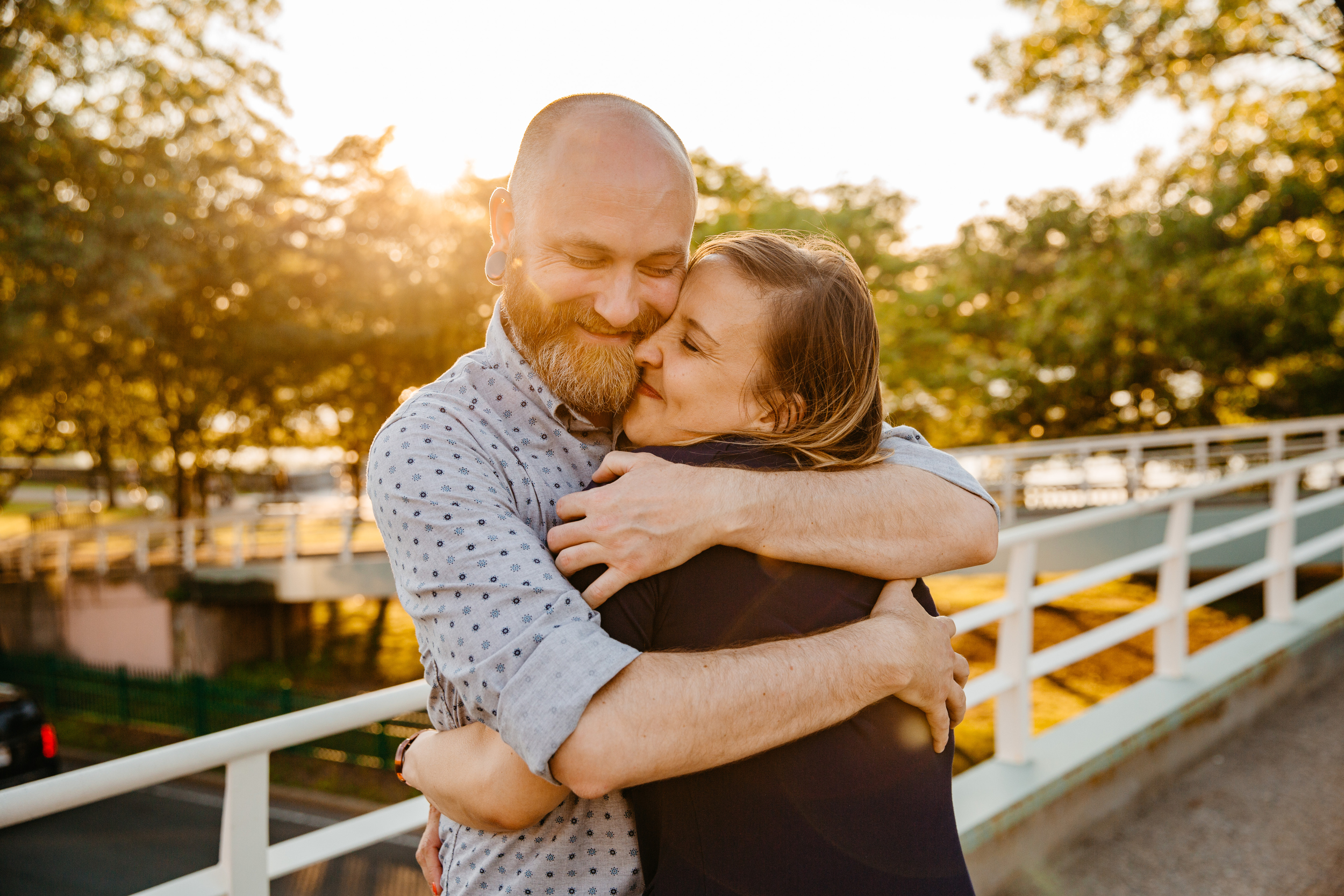  couple hugging at the charles river esplanade during sunset 