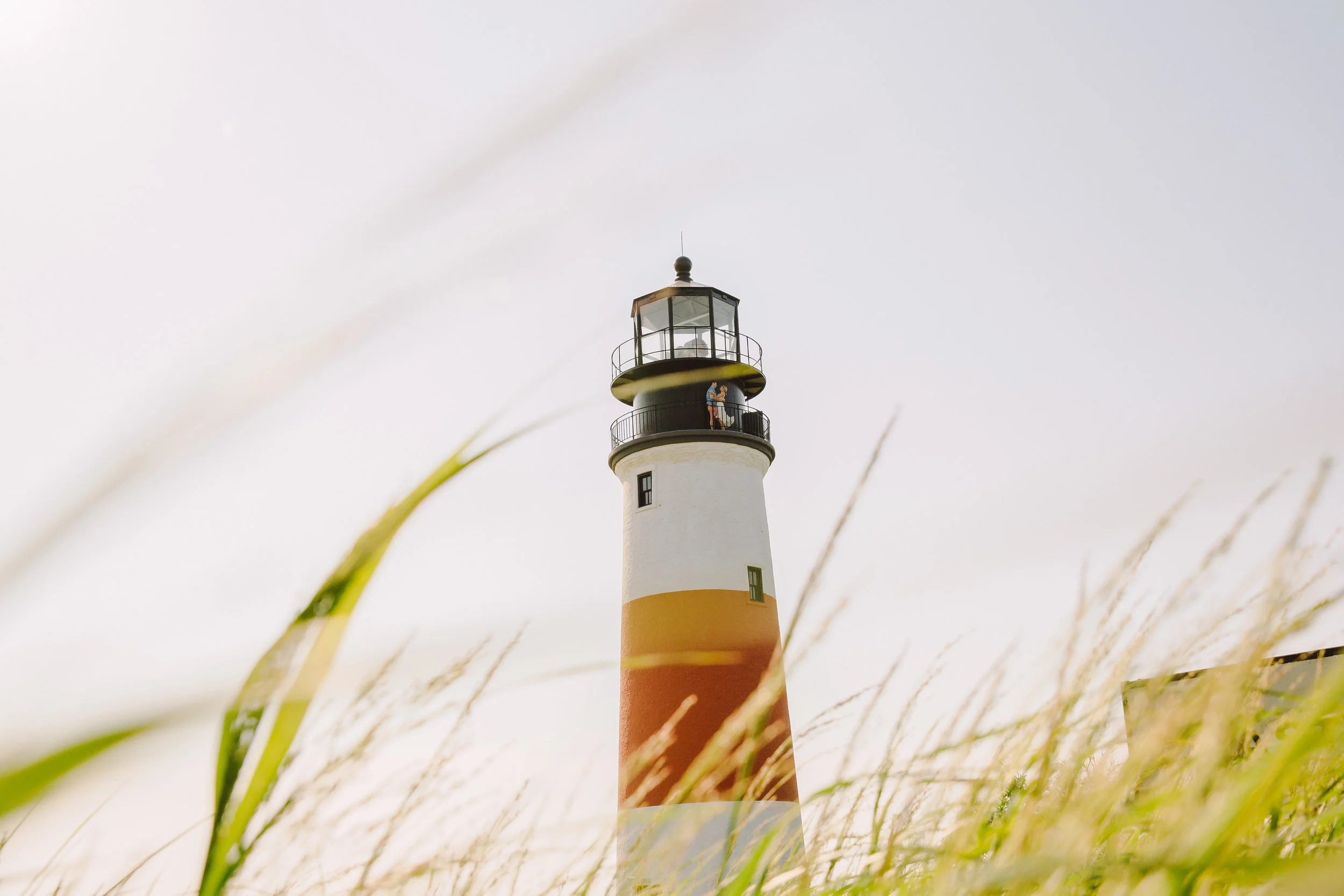 Amazing engagement photos at Sankaty light with the couple inside the lightrhouse