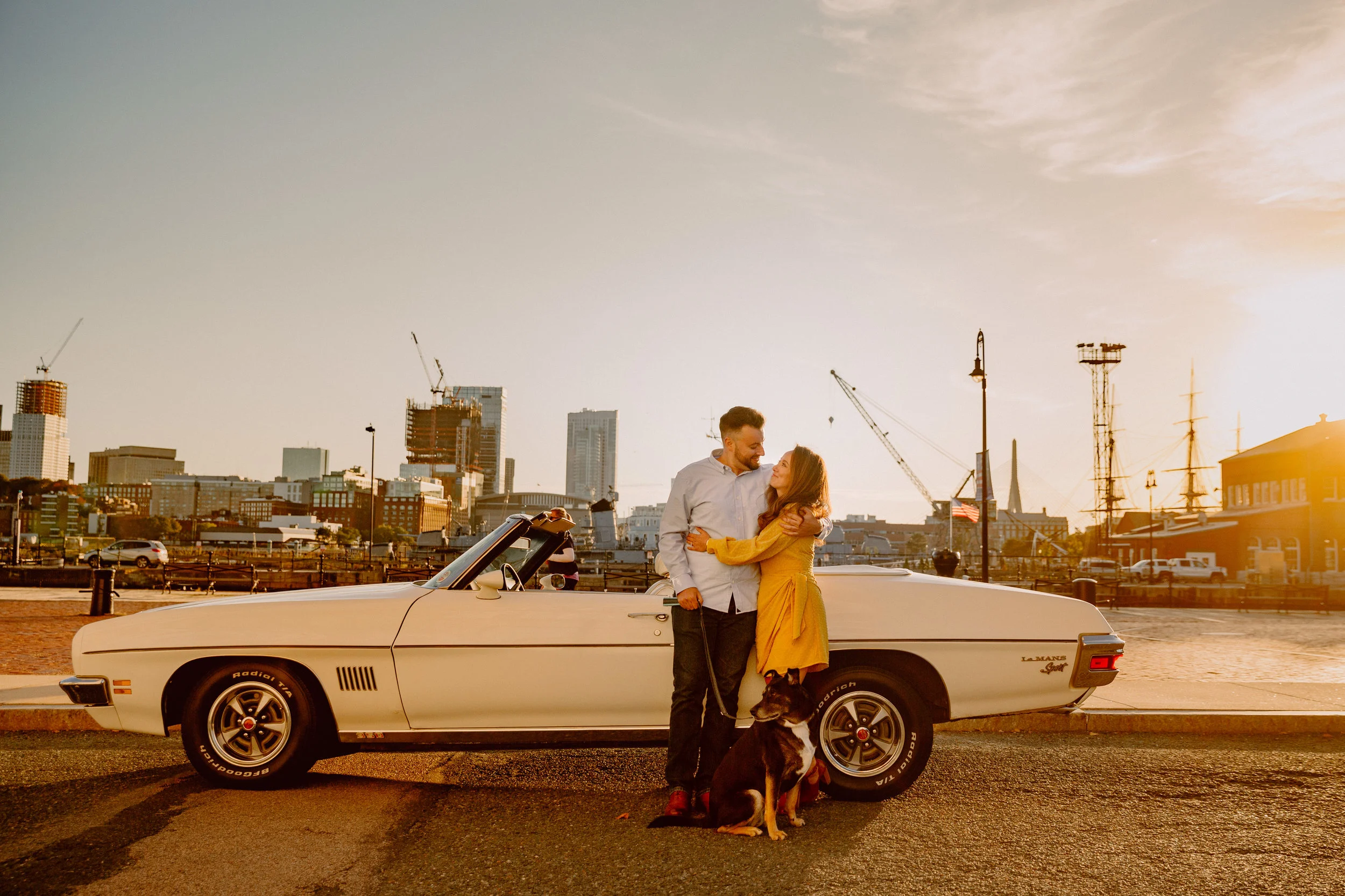 fun city engagement session with classic car and dog in charlestown ma