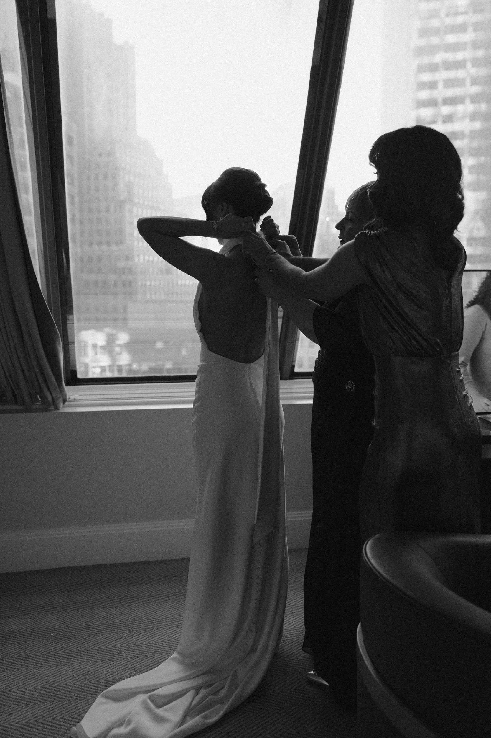 State room documentary style editorial wedding with beautiful couple in downtown Boston black tie wedding with bride with big bow on dress