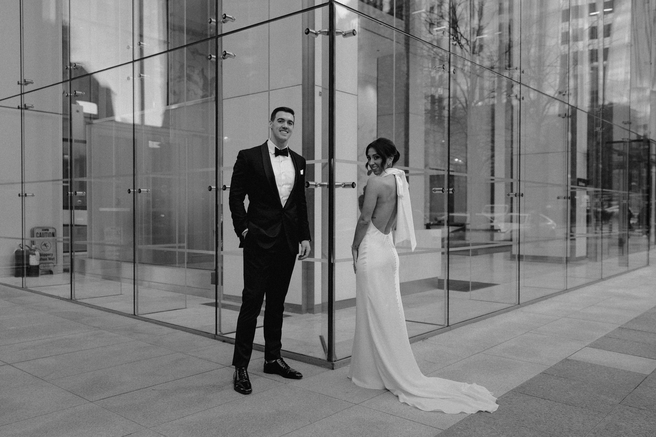 State room documentary style editorial wedding with beautiful couple in downtown Boston black tie wedding with bride with big bow on dress