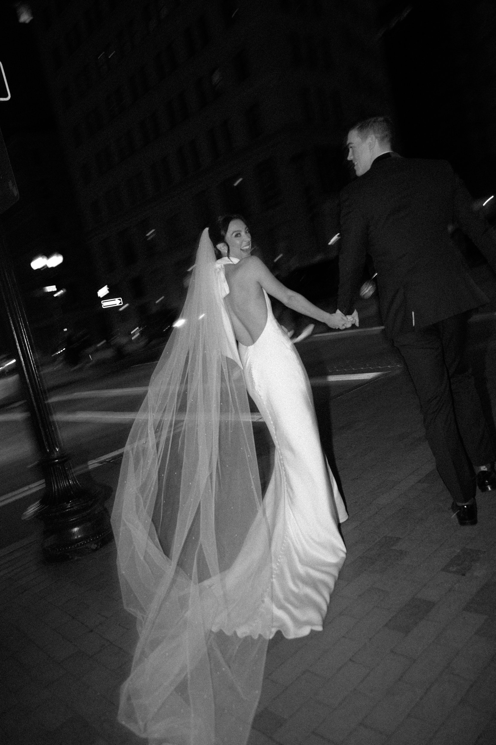 State room documentary style editorial wedding with beautiful couple in downtown Boston black tie wedding with bride with big bow on dress