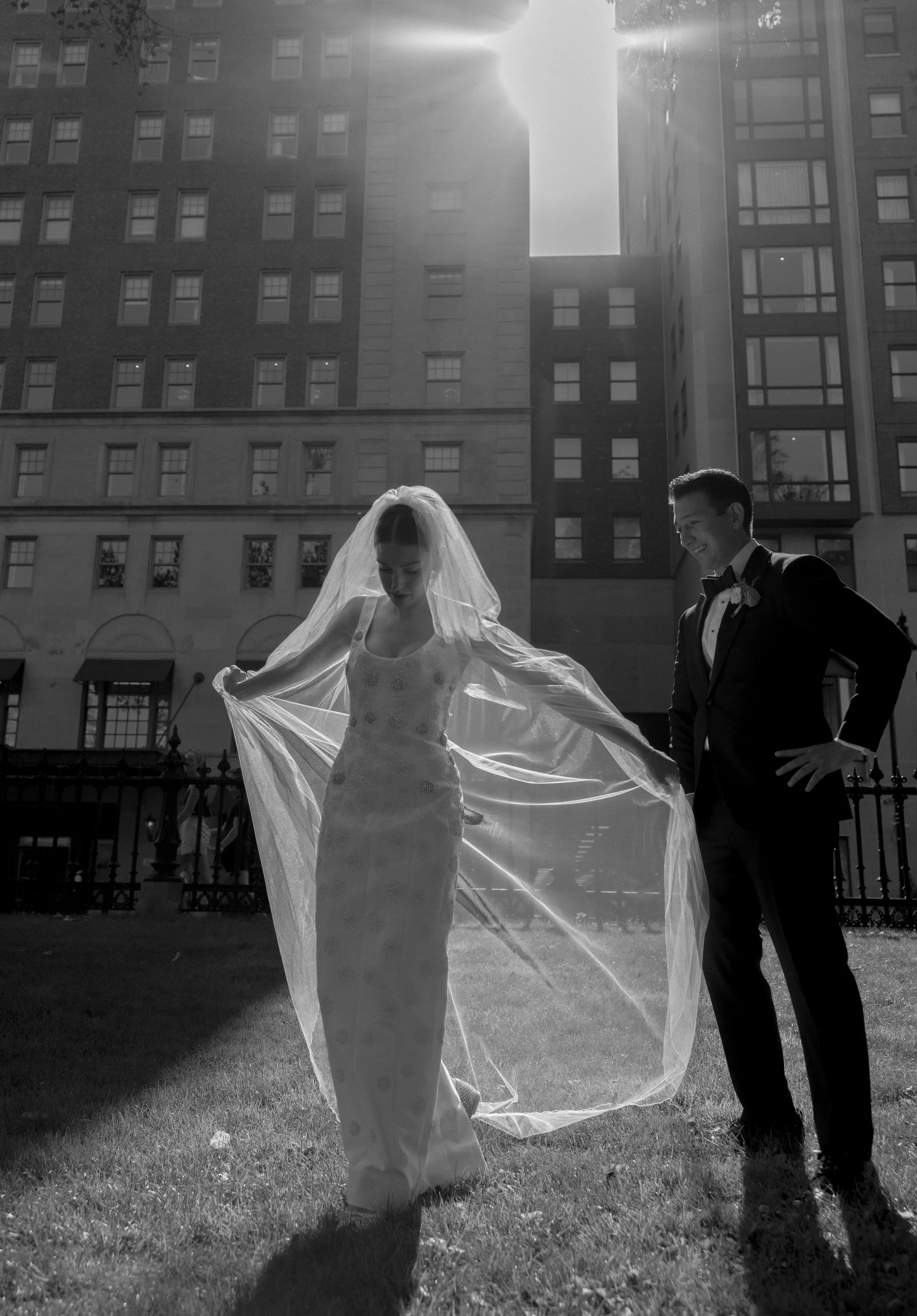 first look with veil in front of the newbury hotel in boston at the public garden