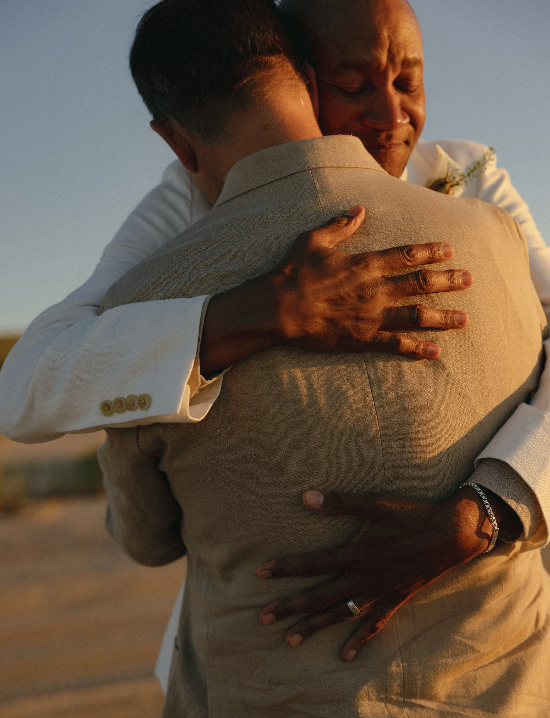 same sex gay couple hugging after their race point beach sunset ceremony