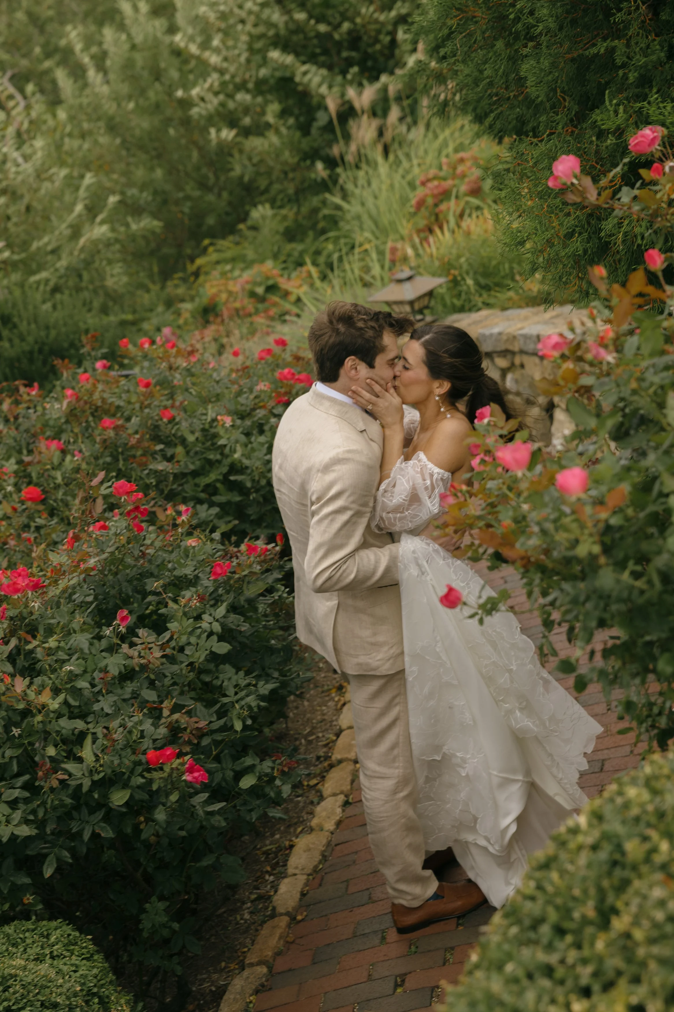 wychmere coastal cape cod wedding couple kissing in garden