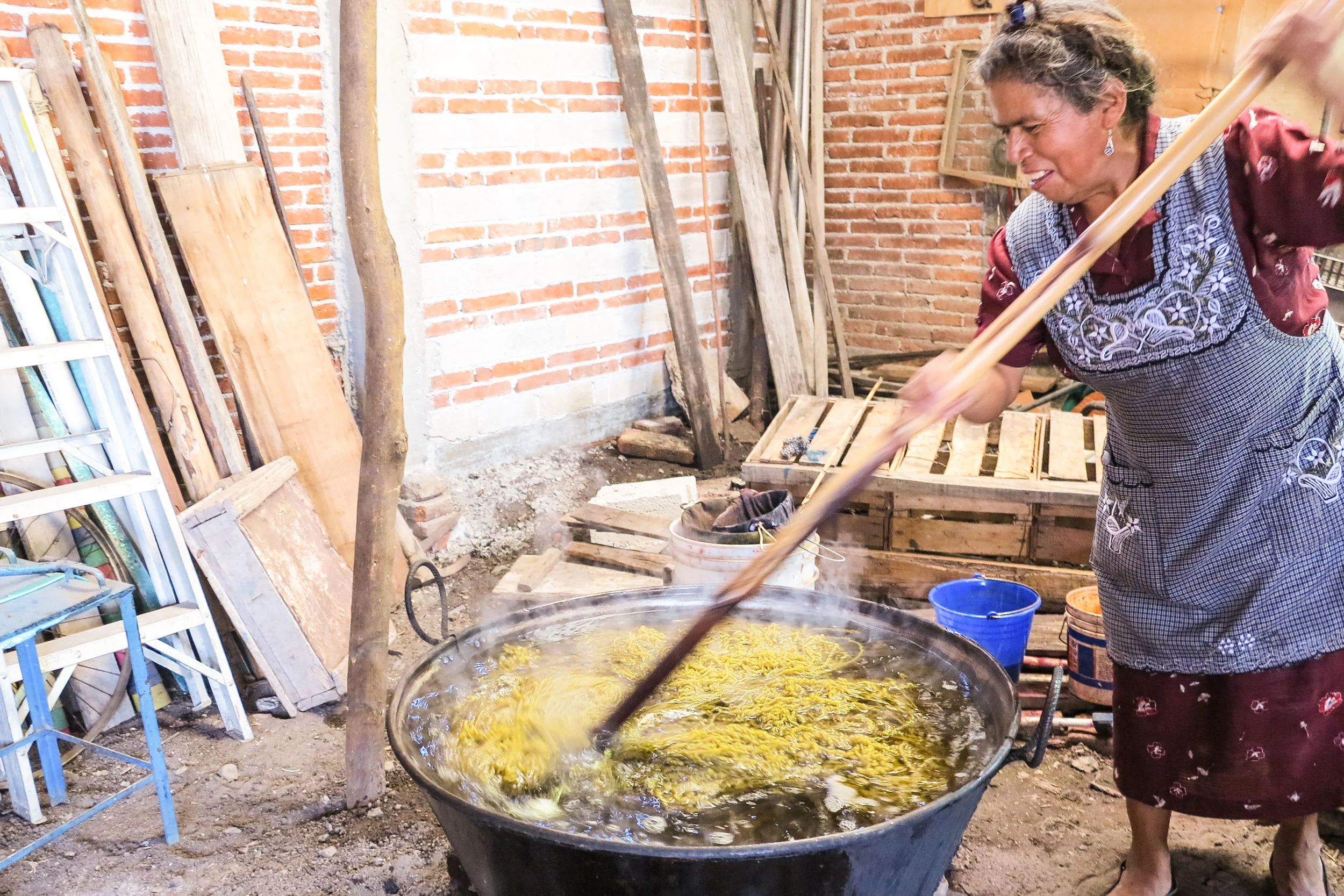 Yarns are collected, washed, and dyed with boiling water in aluminium pot.