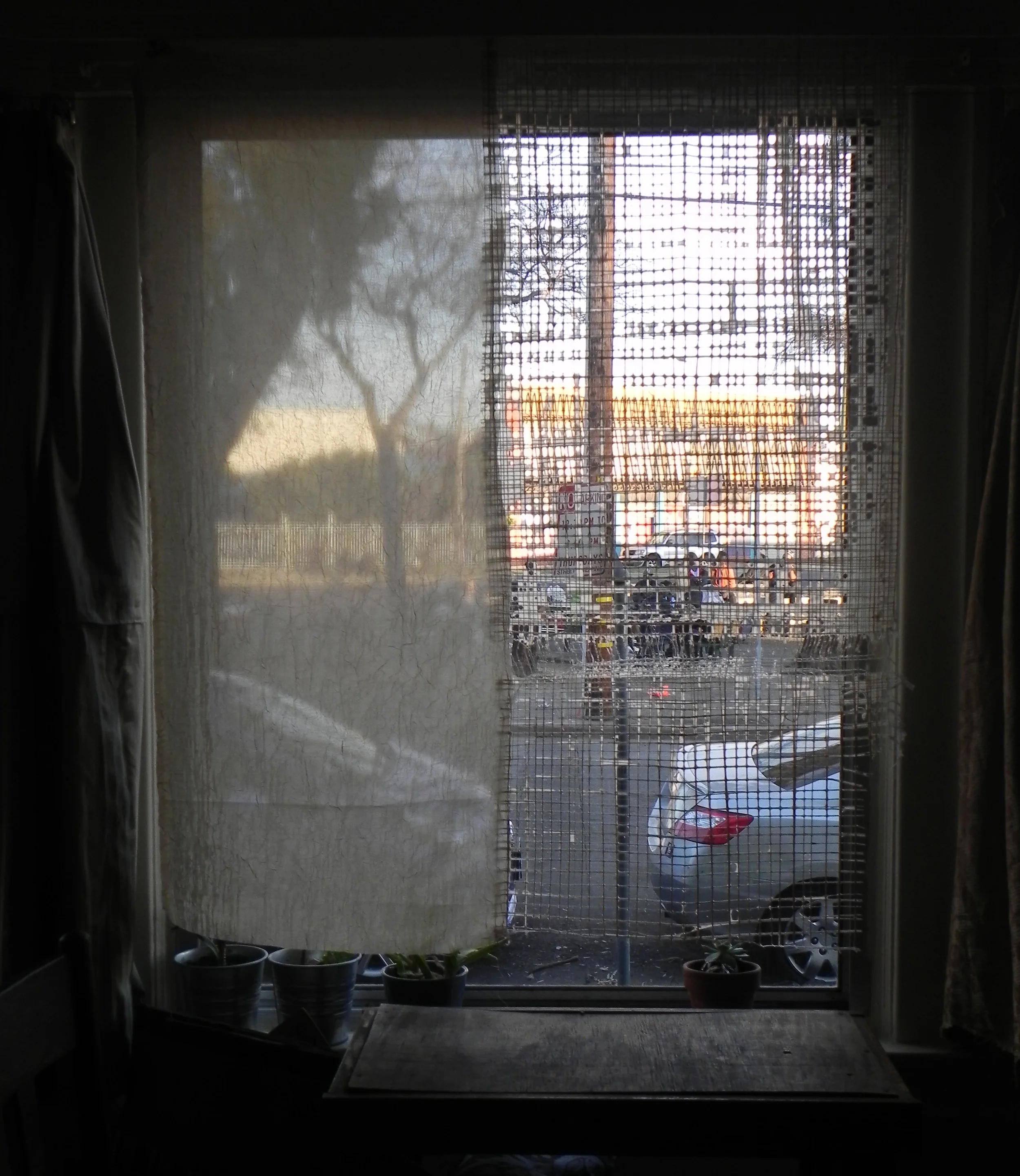 through the window as the sun goes down