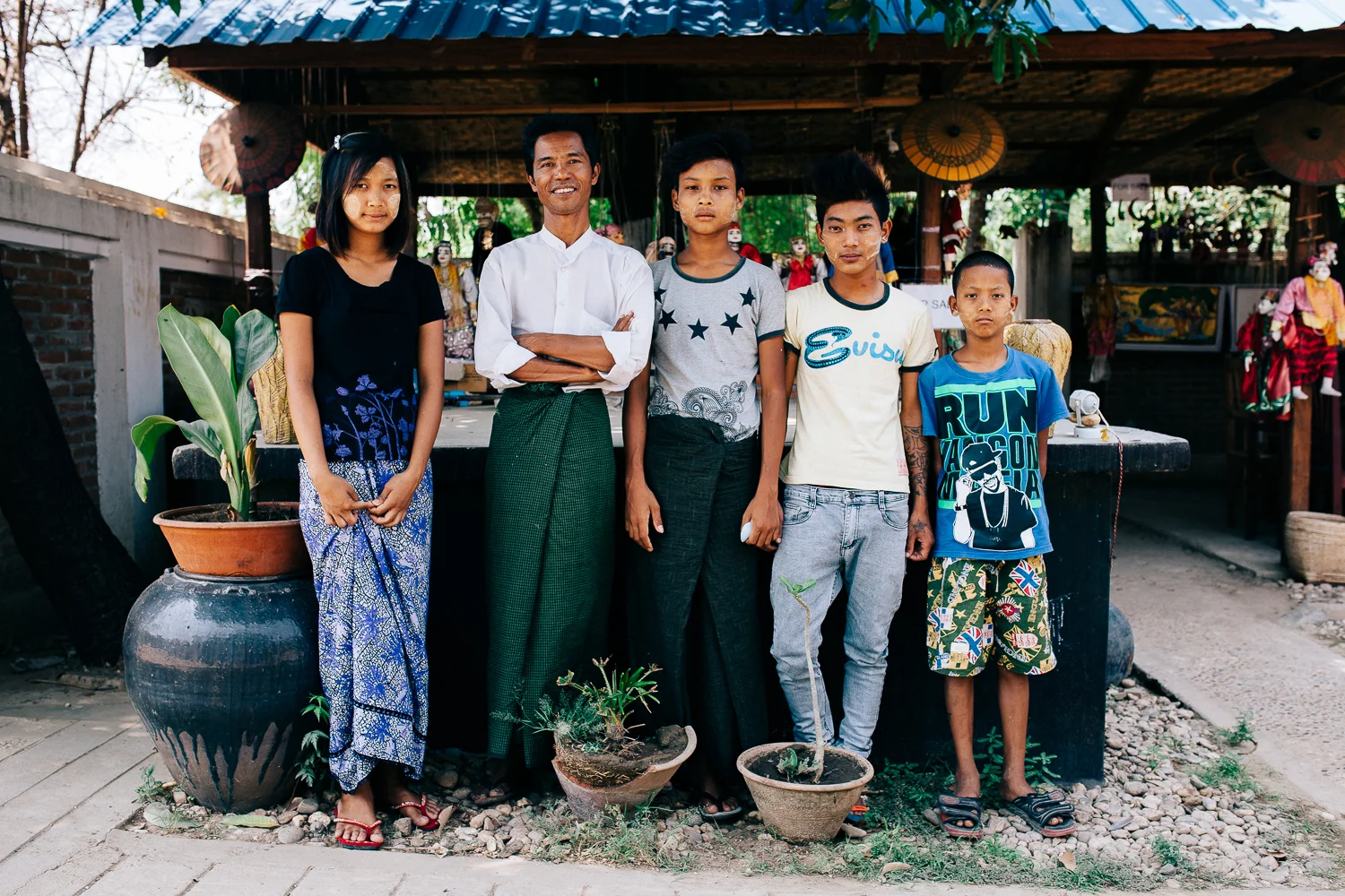 Mr Pho (second from the left) and his family at their restaurant where his children helped him out with his puppet shows as his assistants.