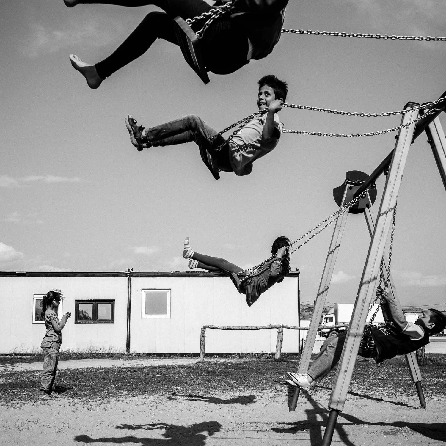 Children playing on a playground in Nea Kavali Camp, Greece, 2016