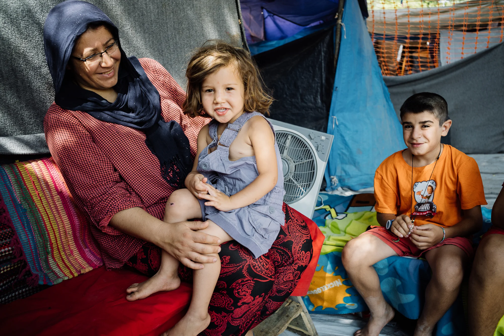 While waiting for breakfast, tea is served as a customary practice. The elder boys pour scores of sugar into their own cups, a sign that is telling of where they get their source of energy from in a limited diet. As we slowly sip into our hot tea, Kurdistan finally comes out from the tent in her new clothes and shyly climb onto her mother's lap as everyone dotes on her.