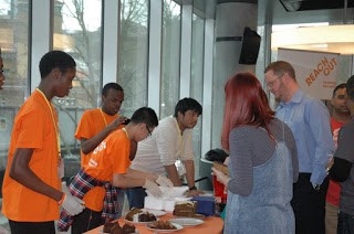 Young people from ReachOut taking part in social action, selling cakes for charity.